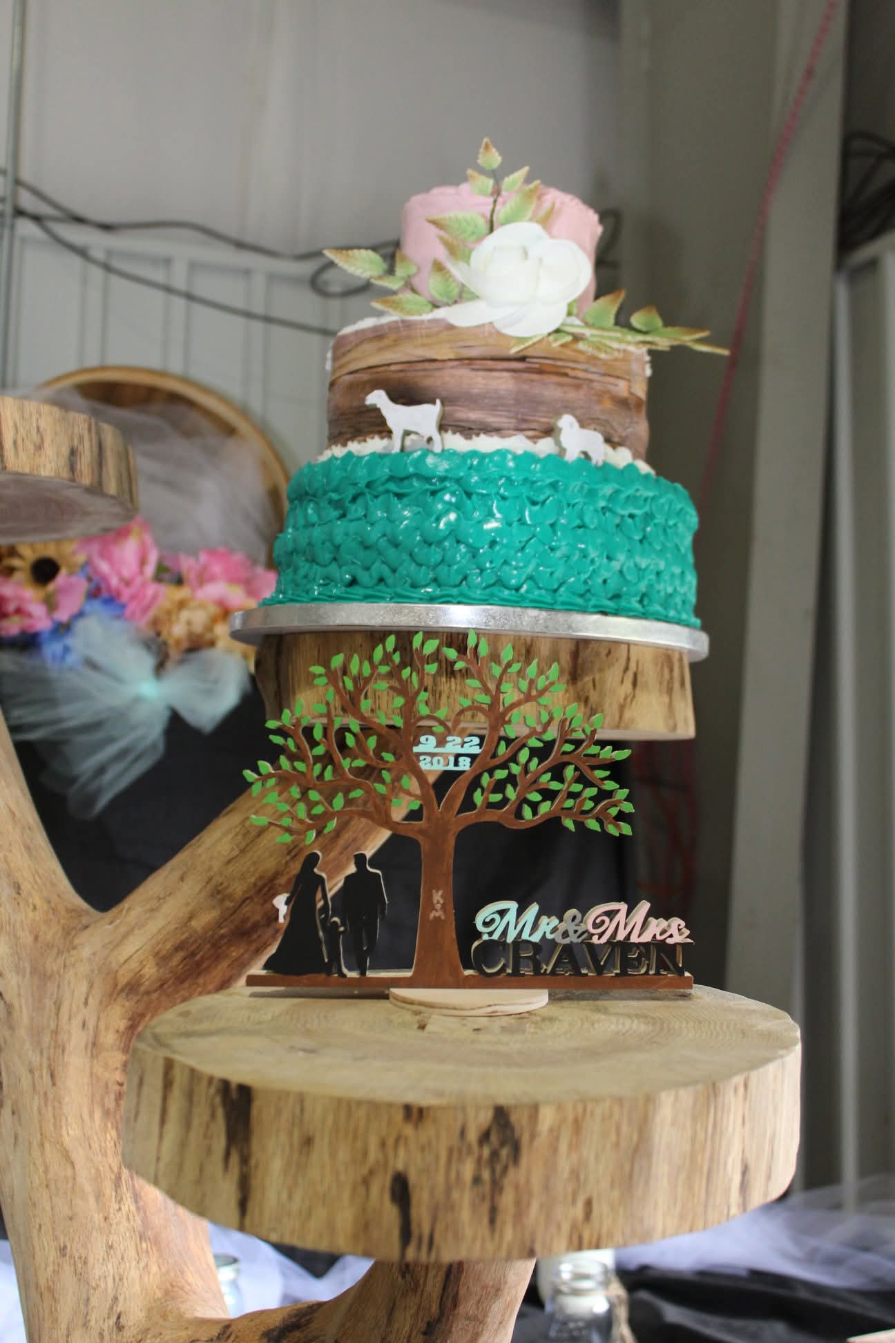 Custom rustic tiered wedding cake with floral topper